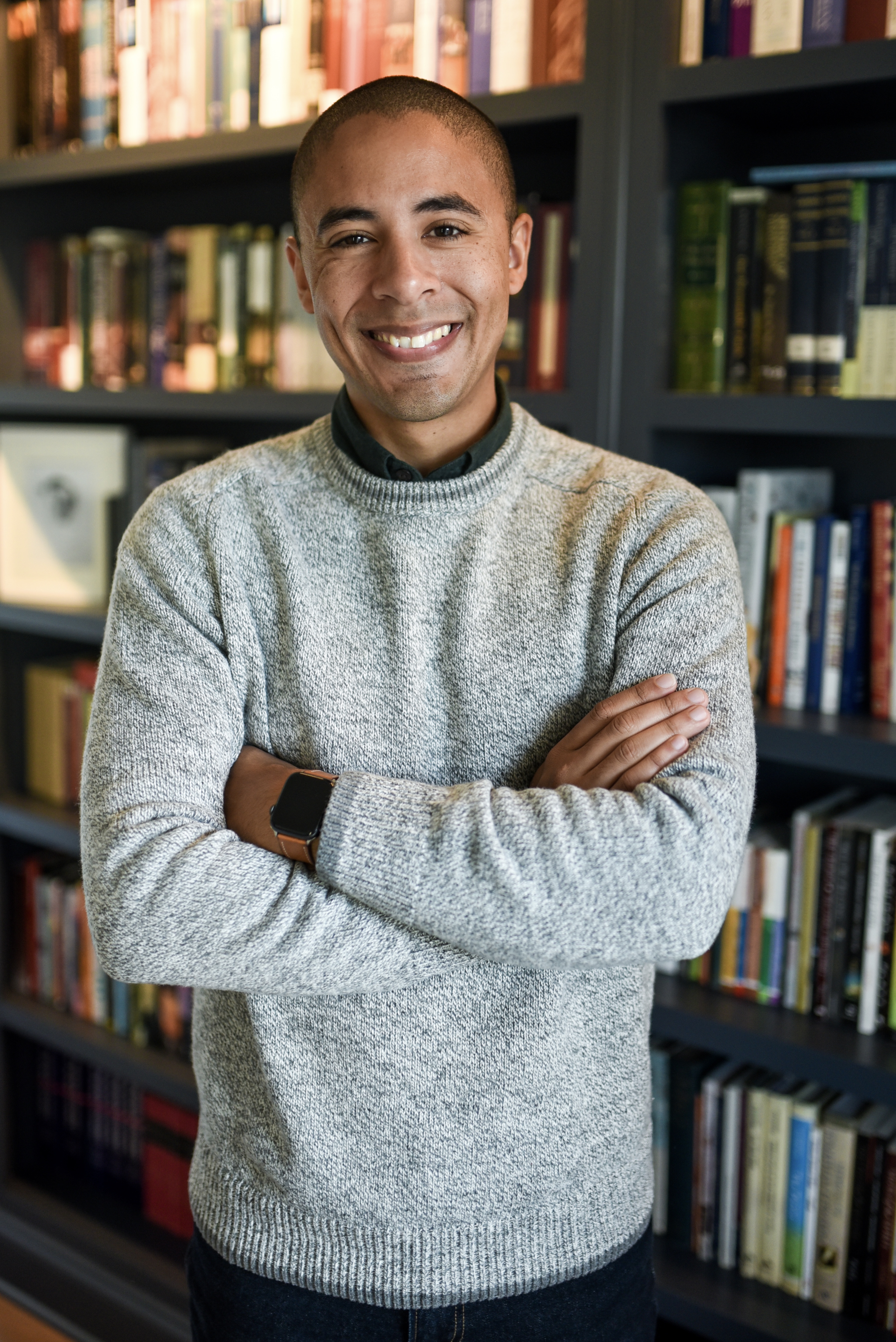 Eric Parker standing in front of a wall of books